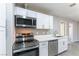 Efficient kitchen featuring white cabinets, modern stainless steel appliances, and sleek countertops at 5800 Auborn Ave, Las Vegas, NV 89108