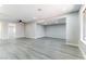Spacious living room with updated lighting and a large opening to another living space at 5800 Auborn Ave, Las Vegas, NV 89108