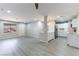 Open-concept living area with gray plank flooring and views of the kitchen and dining area at 5800 Auborn Ave, Las Vegas, NV 89108