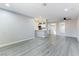 Open-concept living area with gray plank flooring and views of the kitchen and dining area at 5800 Auborn Ave, Las Vegas, NV 89108