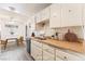 Functional kitchen featuring white cabinets, a window over sink, and an adjacent dining area at 5809 Pebble Beach Blvd, Las Vegas, NV 89108