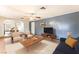 Spacious living room with wood-look floors, neutral walls, and a comfortable seating arrangement at 5809 Pebble Beach Blvd, Las Vegas, NV 89108