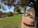 Lush backyard featuring artificial turf, a pool, a covered patio, and ample seating for relaxation at 6293 Pavestone Ln, Las Vegas, NV 89142