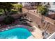 Backyard view features a pool, fire pit, outdoor furniture, and privacy walls at 6293 Pavestone Ln, Las Vegas, NV 89142