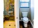 Tiled bathroom featuring a shower, toilet and window with blue blinds at 6293 Pavestone Ln, Las Vegas, NV 89142