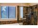 Modern bathroom features a glass shower with mosaic tile, a window, and updated fixtures at 6293 Pavestone Ln, Las Vegas, NV 89142