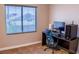 Bedroom with a computer desk, ergonomic chair, and bright window with blinds at 6293 Pavestone Ln, Las Vegas, NV 89142