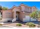 Charming stucco home features a red tile roof, arched entry, and a two-car garage at 6293 Pavestone Ln, Las Vegas, NV 89142