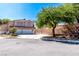 Two-story home with three-car garage, tile roof, and manicured front yard at 6293 Pavestone Ln, Las Vegas, NV 89142