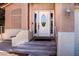 Charming home front door entrance with decorative window and stucco pillars at 6293 Pavestone Ln, Las Vegas, NV 89142
