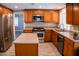 Modern kitchen featuring stainless steel appliances, an island, and wood cabinets at 6293 Pavestone Ln, Las Vegas, NV 89142