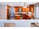 Modern kitchen featuring an island, stainless steel appliances, and wood cabinets at 6293 Pavestone Ln, Las Vegas, NV 89142