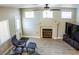 Living room showcasing a fireplace, ceiling fan, and television on wooden floors at 6293 Pavestone Ln, Las Vegas, NV 89142