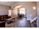 Open-concept living area featuring a sofa, dining area, archway, and staircase at 6293 Pavestone Ln, Las Vegas, NV 89142