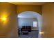 A comfortable living room with a maroon sofa and a view from an archway at 6293 Pavestone Ln, Las Vegas, NV 89142