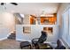 Sitting area featuring hardwood floors, two chairs, and views into the modern kitchen at 6293 Pavestone Ln, Las Vegas, NV 89142