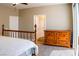 Bedroom featuring a wooden bed frame, dresser, plush carpet, and sliding glass door to a balcony at 6293 Pavestone Ln, Las Vegas, NV 89142