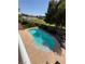 Inviting backyard pool with a spacious concrete deck and views of the neighborhood park at 6293 Pavestone Ln, Las Vegas, NV 89142
