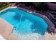 Backyard pool features light blue water, stone trim, and lush landscaped surroundings at 6293 Pavestone Ln, Las Vegas, NV 89142