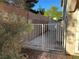 Side yard with a metal gate, block wall, and access to the backyard at 6293 Pavestone Ln, Las Vegas, NV 89142