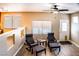 Comfortable sitting area with wood floors, windows, and ceiling fan for relaxation at 6293 Pavestone Ln, Las Vegas, NV 89142