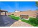 Low maintenance backyard with artificial grass, desert landscaping, a spa, and hardscape at 6602 Windy Palm St, North Las Vegas, NV 89086