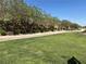 Expansive green space with mature trees and a walking path offers a serene outdoor experience at 664 Forest Peak St, Henderson, NV 89011