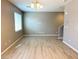 Living room featuring wood floors, modern lighting fixture, and view of stairs at 664 Forest Peak St, Henderson, NV 89011