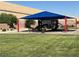 Community playground featuring shade structure and play equipment on a grassy lawn at 664 Forest Peak St, Henderson, NV 89011