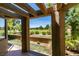 View of golf course from covered back patio with desert landscaping and beautiful pergola at 7132 Mission Hills Dr, Las Vegas, NV 89113