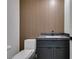 Stylish half bathroom featuring modern fixtures, wood accents, and sleek design at 7132 Mission Hills Dr, Las Vegas, NV 89113