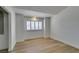 Bright bedroom featuring wood floors, neutral walls, and a window with white shutters at 7132 Mission Hills Dr, Las Vegas, NV 89113