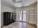 Well-lit room featuring modern ceilings fan, built-in storage, and patio access at 7132 Mission Hills Dr, Las Vegas, NV 89113