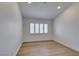 Cozy bedroom boasting wood floors, neutral walls, and a window with white shutters at 7132 Mission Hills Dr, Las Vegas, NV 89113