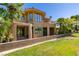 Mediterranean-style two-story home showcasing multiple balconies and an inviting outdoor space with lush landscaping at 7132 Mission Hills Dr, Las Vegas, NV 89113