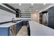 Spacious kitchen with stainless steel appliances, dark cabinets, quartz countertops and island seating at 7132 Mission Hills Dr, Las Vegas, NV 89113