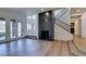 Bright, open living room with wood floors, fireplace, staircase, and many windows at 7132 Mission Hills Dr, Las Vegas, NV 89113