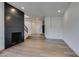 Spacious living room with fireplace, light wood floors, and open floor plan at 7132 Mission Hills Dr, Las Vegas, NV 89113