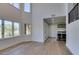 Bright living room with large windows and light wood floors with a wet bar area at 7132 Mission Hills Dr, Las Vegas, NV 89113