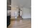 Open living room with light wood flooring, entryway, and raised platform at 7132 Mission Hills Dr, Las Vegas, NV 89113