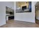 Bright living room showcasing wood floors, an open staircase, and a glimpse of the kitchen at 7132 Mission Hills Dr, Las Vegas, NV 89113