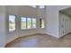 Living room with large windows and light wood floors overlooking landscaped yard at 7132 Mission Hills Dr, Las Vegas, NV 89113