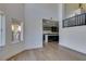 Open-concept living room featuring light wood floors, leading into the kitchen area at 7132 Mission Hills Dr, Las Vegas, NV 89113