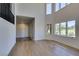 Open concept living room with high ceilings, large windows, and a bar at 7132 Mission Hills Dr, Las Vegas, NV 89113