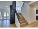 Bright entry features sleek stairs with modern black railings and views to the backyard at 7132 Mission Hills Dr, Las Vegas, NV 89113