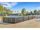 Outdoor tennis court featuring well-maintained courts, lighting and benches at 7132 Mission Hills Dr, Las Vegas, NV 89113
