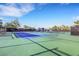 Outdoor tennis court featuring well-maintained blue and green courts and benches at 7132 Mission Hills Dr, Las Vegas, NV 89113