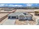 Newly constructed home features a desert landscape, with stone accents, a paved driveway and a spacious two-car garage at 7141 Painted Skyline St, Las Vegas, NV 89118