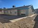 Exterior view of a house with a large concrete patio and desert landscaping at 725 Brick Dr, Henderson, NV 89002