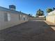 The backyard features a concrete patio, desert landscaping, and a block wall at 725 Brick Dr, Henderson, NV 89002